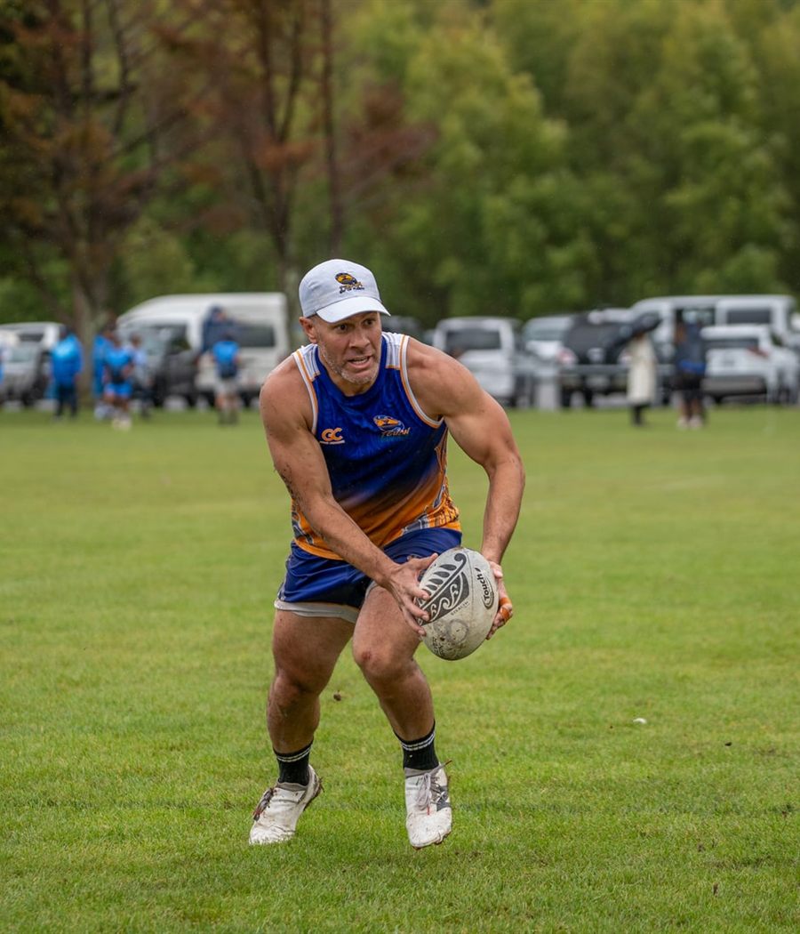 A Game Changer touch player in custom kit, mid-play with the ball.